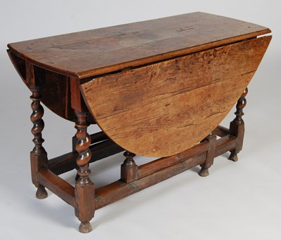 Lot 72 - An 18th/19th century oak gateleg dining table...