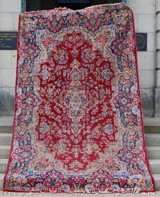 Lot 133 - A Persian rug, the rectangular madder ground...