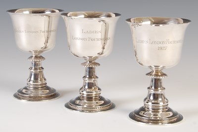 Lot 325 - A set of three George V silver goblets, London,...