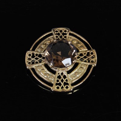 Lot 394 - A 9ct gold and smoky quartz brooch, centred...