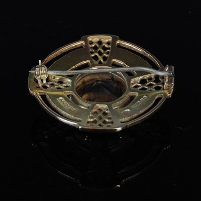 Lot 394 - A 9ct gold and smoky quartz brooch, centred...