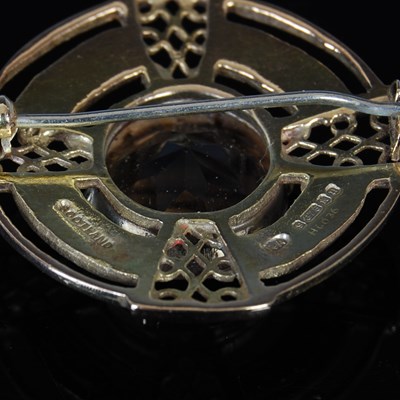 Lot 394 - A 9ct gold and smoky quartz brooch, centred...
