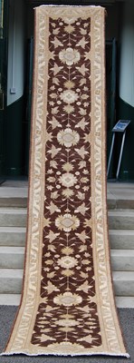 Lot 140 - A long Persian runner, 20th century, the earth...