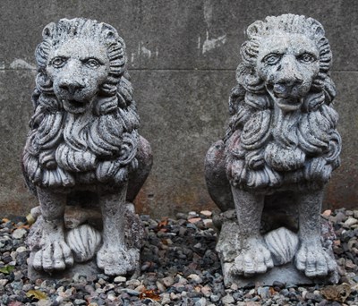 Lot 117 - A pair of composite stone garden lions, 20th...