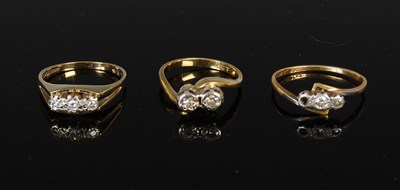 Lot 409 - A 9ct gold and diamond three stone ring,...