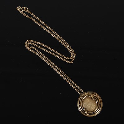 Lot 408 - A 9ct gold pendant and chain, the circular...