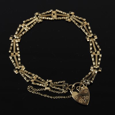 Lot 406 - A yellow metal gatelink bracelet, with 9ct...