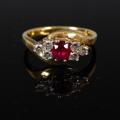 Lot 442 - An 18ct gold ruby and diamond ring, centred...