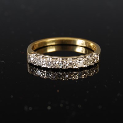 Lot 417 - A yellow metal and diamond half hoop ring, set...