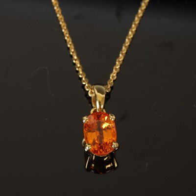 Lot 390 - An 18ct gold mounted mandarin garnet pendant...