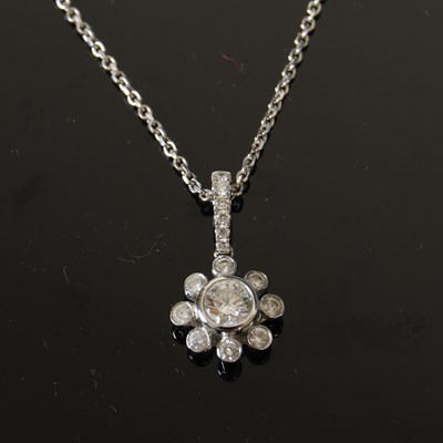 Lot 444 - An 18ct white gold and diamond cluster pendant...