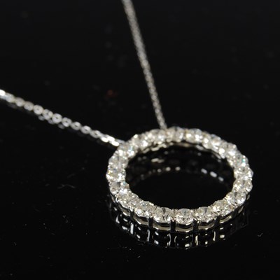 Lot 447 - An 18ct white gold and diamond circular...