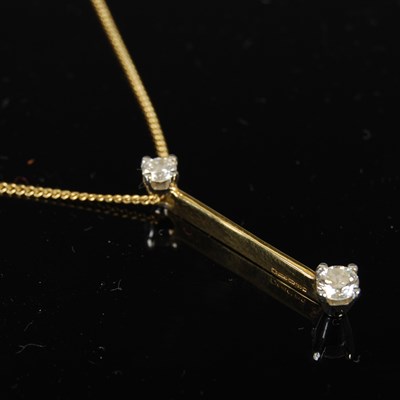 Lot 430 - An 18ct gold and diamond two pendant...