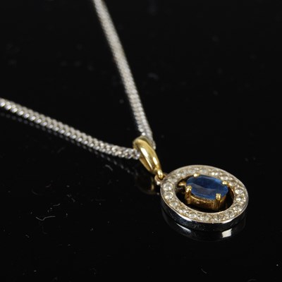 Lot 424 - An 18ct yellow and white gold sapphire and...