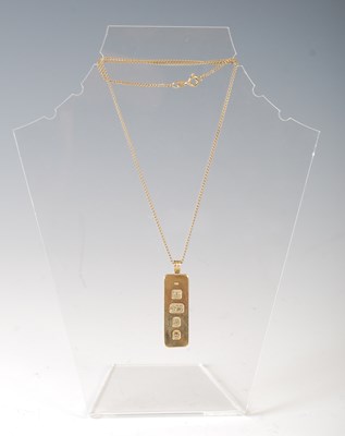 Lot 382B - A 9ct gold ingot pendant suspended on yellow...