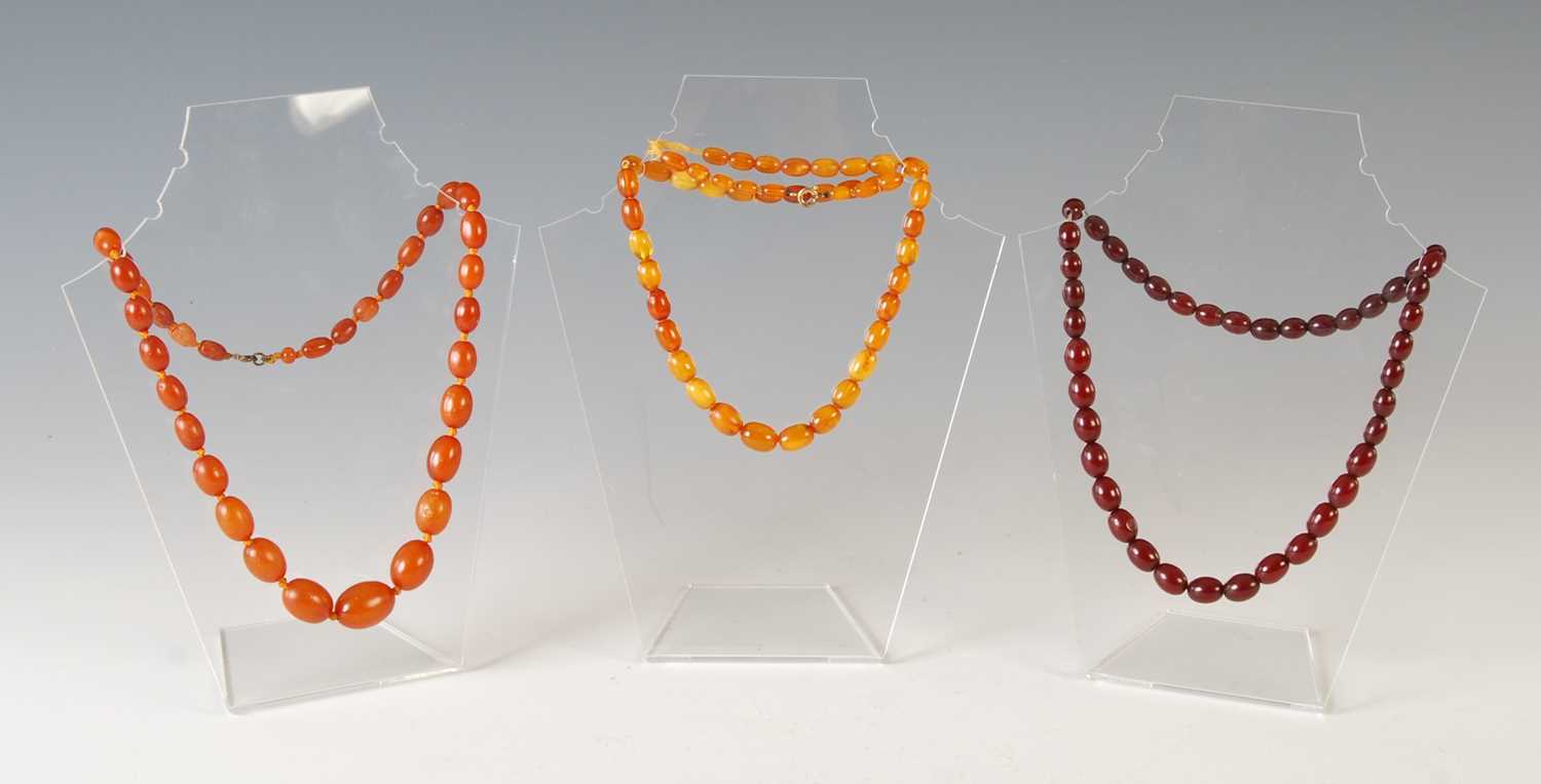Lot 382 - A group of three amber graduated bead