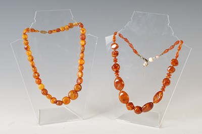 Lot 382H - A graduated amber bead necklace, 41cm long,...