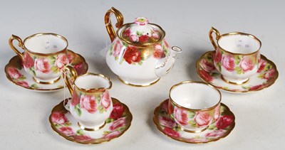 Lot 7 - A Royal Albert rose decorated tea set for two.