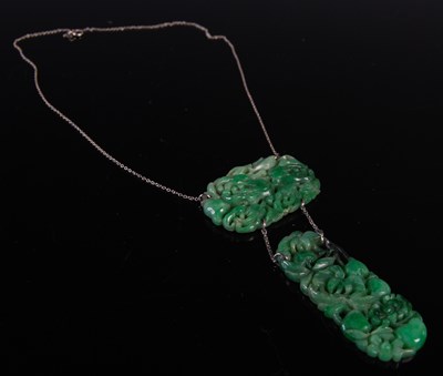 Lot 37 - An early 20th century jade pendant suspended...