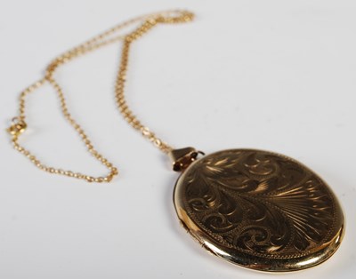 Lot 54 - A 9ct gold oval-shaped locket suspended on...