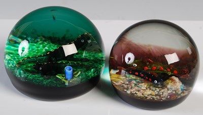 Lot 140 - Two clear and coloured glass paperweights, one...