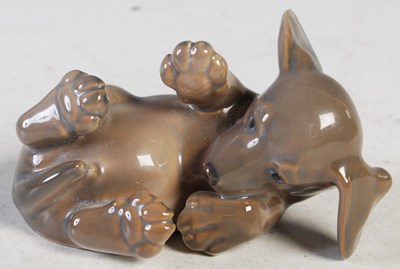 Lot 164 - A Royal Copenhagen model of a puppy lying on...