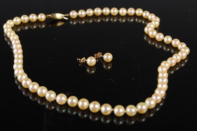 Lot 179 - A single-strand pearl necklace with yellow...