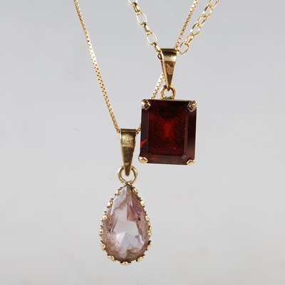 Lot 183 - A 9ct gold necklace suspending oval faceted...