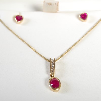 Lot 250 - A modern 9ct gold ruby and diamond chip...