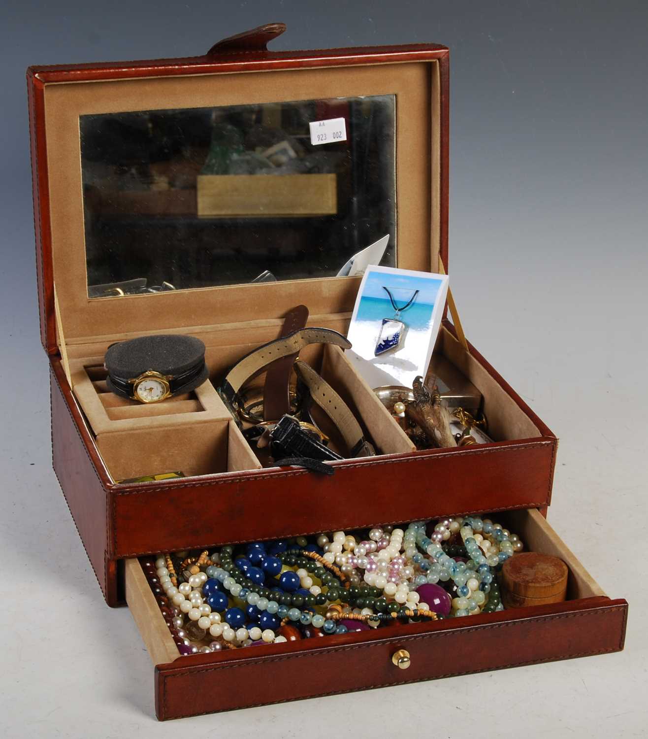 Lot 259 - A brown leather jewellery box containing a