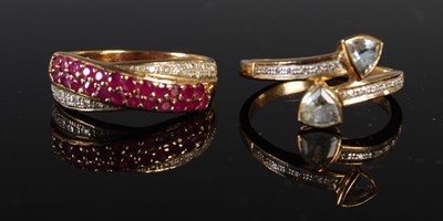 Lot 301 - Two yellow metal and gem set dress rings, one...