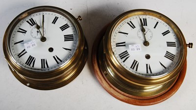 Lot 343 - Two ships' brass cased bulkhead wall clocks,...