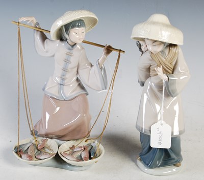 Lot 413 - A pair of Lladro porcelain figure groups, girl...