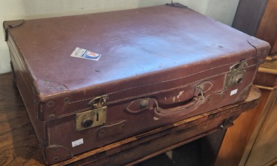 Lot 715 - A vintage leather cased suitcase.