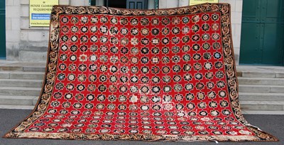 Lot 753 - A large red ground needlework carpet, worked...