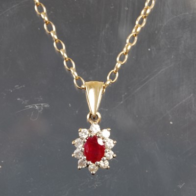 Lot 249G - A 9ct gold necklace suspending 9ct gold ruby...