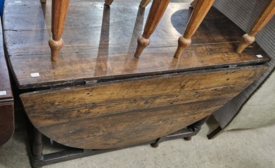 Lot 861 - A 17th/18th century oak drop-leaf dining table,...