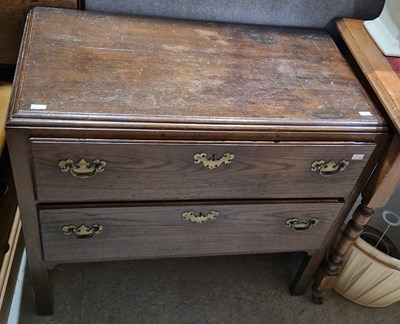 Lot 910 - An antique oak chest of two long drawers...