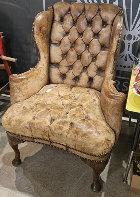 Lot 916 - A George III style leather upholstered wing...