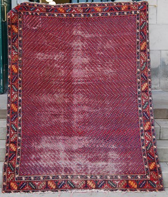 Lot 770 - A Persian rug, 20th century, the madder ground...