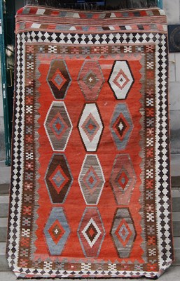 Lot 942 - A kilim rug, the rectangular madder ground...