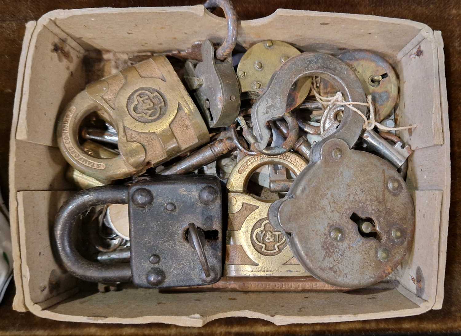 Lot 540 - A box containing assorted antique padlocks and...
