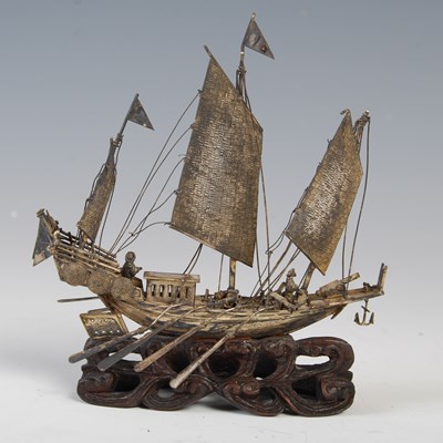 Lot 84T - A Chinese white metal model of a junk sailing...