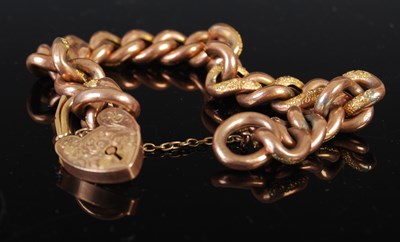 Lot 43K - A 9ct gold bracelet with heart shaped lock,...