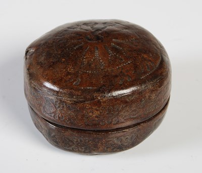 Lot 340 - An early pressed leather circular bun-shaped...