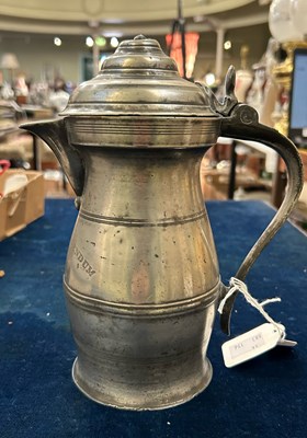 Lot 133 - An 18th century pewter lidded jug of baluster...