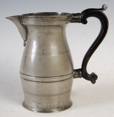 Lot 127 - A late 18th century pewter baluster jug with...