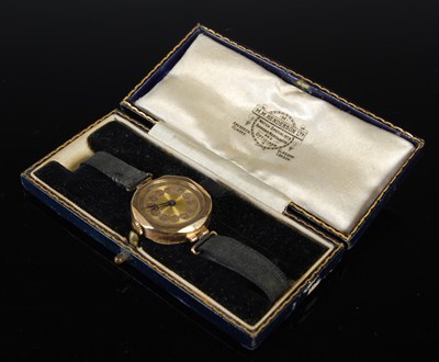 Lot 44 - A 9ct gold wristwatch with black satin strap,...