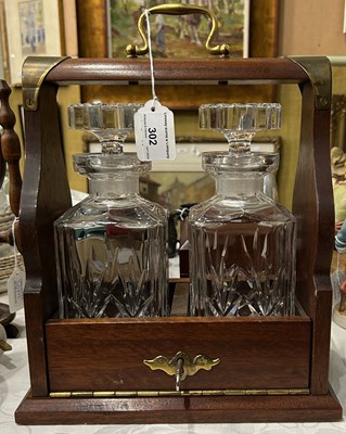 Lot 302 - A mahogany and brass two bottle tantalus,...