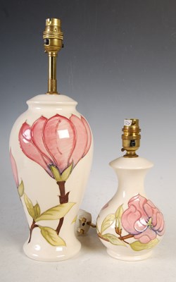 Lot 308 - Two white ground Moorcroft table lamps,...